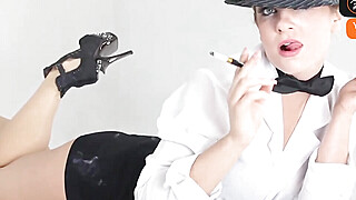 A blond gal in a white tee-shirt and bow bind enjoys smoking during a... Porn Video